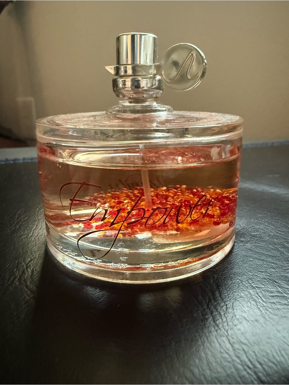 Vanity Empower Eau de Parfum in Clear Bottle with Red-Orange Accents
